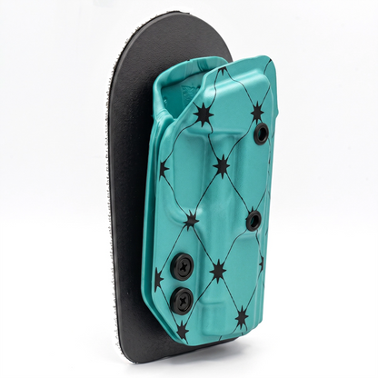 CAKES CONCEALED PRINTED AQUA HOLSTER ON A BLACK VELCRO BACKER SIDE ANGLE.