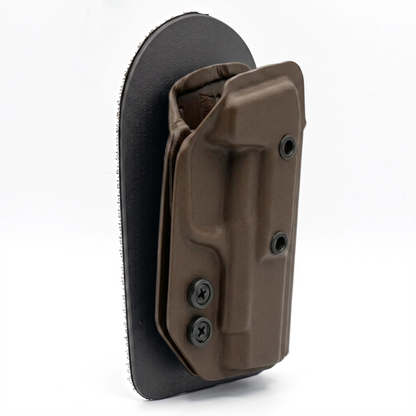 CHOCOLATE CAKES CONCEALED HOLSTER ANGLED TO THE SIDE ON A VELCRO BACKER.