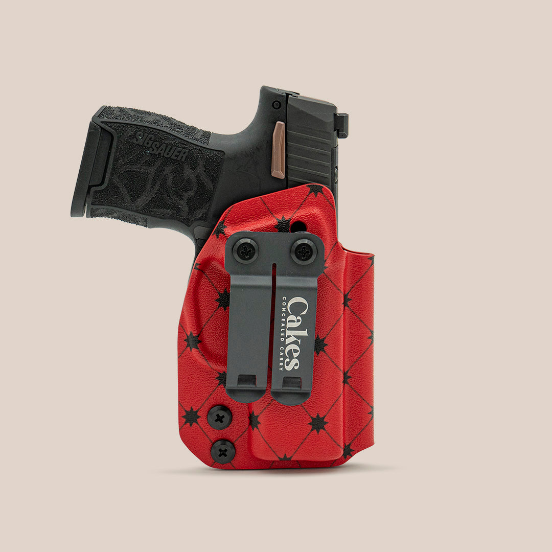 Red quilted concealed carry holster with black belt clip for handgun