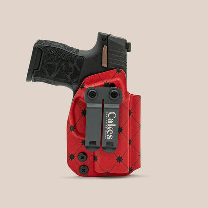 Red quilted concealed carry holster with black belt clip for handgun