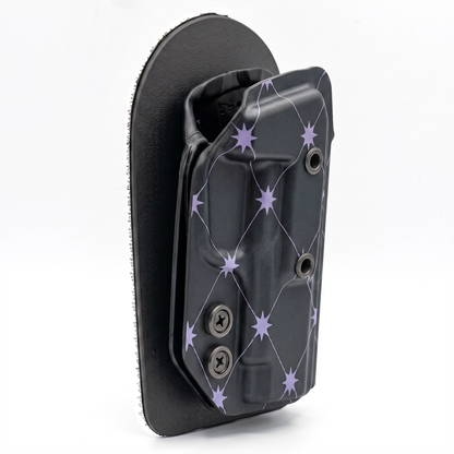 CAKES CONCEALED TARO PREMIUM HOLSTER ON A BLACK VELCRO BACKER ANGLED.